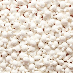 May include: White sugar sprinkles shaped like bunnies. These are perfect for decorating cakes, cupcakes, and cookies.
