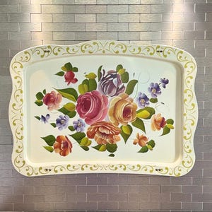 May include: A rectangular serving tray with a cream-colored base and a scalloped edge. The border features a yellow scrollwork pattern. The center displays a hand-painted floral arrangement with roses in shades of pink, orange, and purple, accented by green leaves.