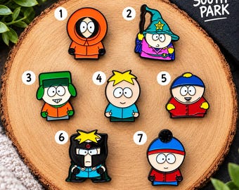 May include: Seven South Park enamel pins numbered one through seven. The pins feature characters in various outfits including an orange parka, a wizard hat, a green ushanka, a blue hat, a red jacket, a black helmet, and a blue beanie.