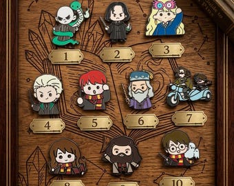 May include: A collection of ten enamel pins featuring chibi-style characters from a fantasy series, arranged on a wooden board with numbered gold plaques. Characters include a snake-wielding figure, a wizard, a girl with glasses, and others.