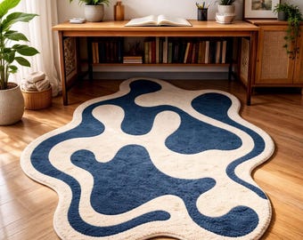 1 modern, minimalist plush rug featuring flowing blue and white lines and an irregular shape