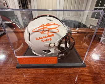 Johnny Manziel Signed Cleveland Browns Mini Helmet – “Cleveland Sucks” Inscription (Beckett Witnessed), acrylic case with custom nameplate