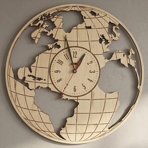May include: A circular wall clock crafted from light-colored wood, featuring a laser-cut world map design with longitudinal and latitudinal grid lines. The central clock face displays black Arabic numerals from 1 to 12 with black and red hands.