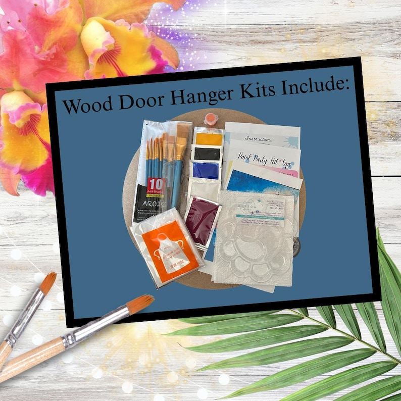 May include: A kit for wood door hangers includes paintbrushes, paint, instructions, and stencils. The kit is displayed on a blue background with the text "Wood Door Hanger Kits Include:" in black. The image is surrounded by flowers and greenery.