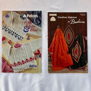 May include: Two vintage knitting pattern booklets. The left booklet is titled Patons Red, White & Blue featuring white sweaters with red and blue accents. The right booklet is titled Patons Carefree Afghans by Beehive showing orange and dark green blankets.