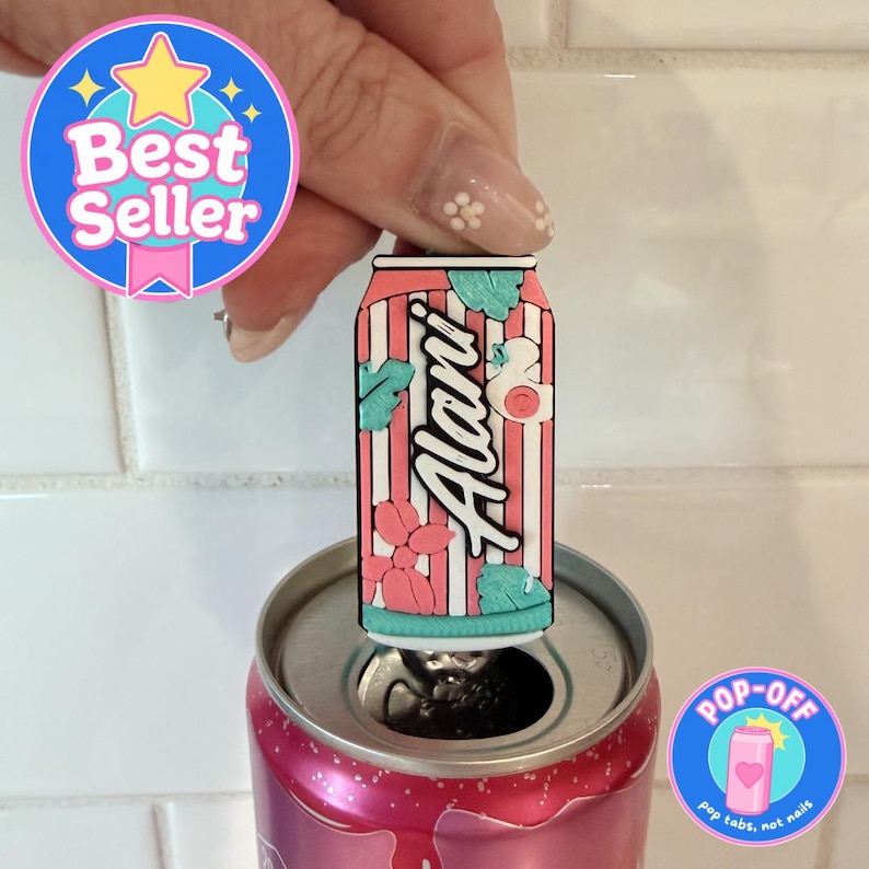 May include: A pink and white striped can-shaped pop-off tool with the name "Alani" in white script. The tool has teal and pink floral and leaf accents. The tool is opening a pink soda can. A "Best Seller" and "Pop-Off" sticker are in the image.