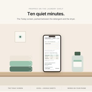 May include: A smartphone displaying the Home Reset Today screen, positioned on a shelf between a stack of three coloured towels and a bottle. Text reads: Propped on the laundry shelf, Ten quiet minutes, The Today screen, parked between the detergent and the dryer, Excel + Google Sheets, Works on your phone.
