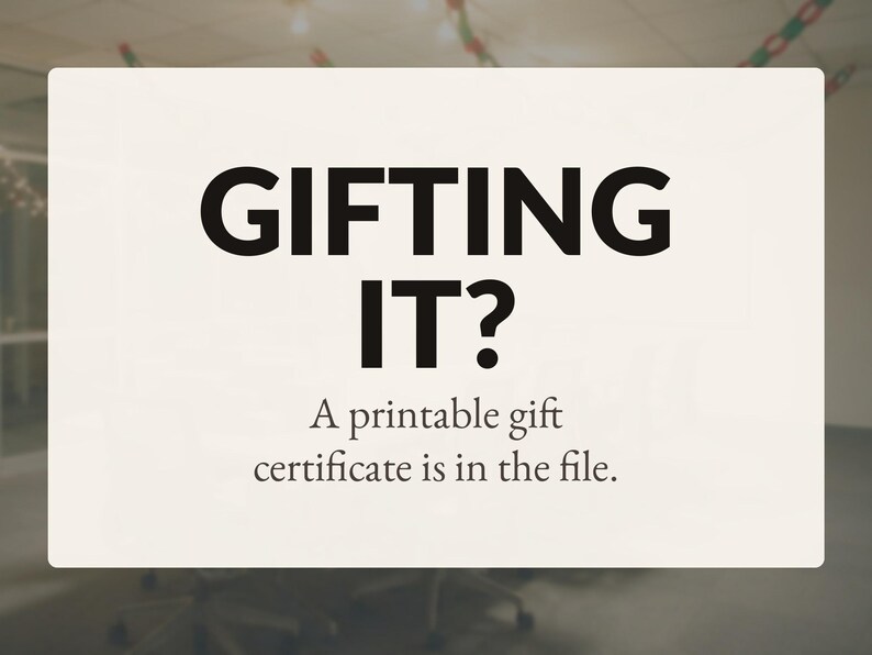 Op de afbeelding: Een rechthoekig gebroken wit bord met zwarte tekst die luidt: GIFTING IT? A printable gift certificate is in the file. De achtergrond is een effen lichte cr&egrave;mekleur met vetgedrukte, donkere letters gecentreerd in het midden.