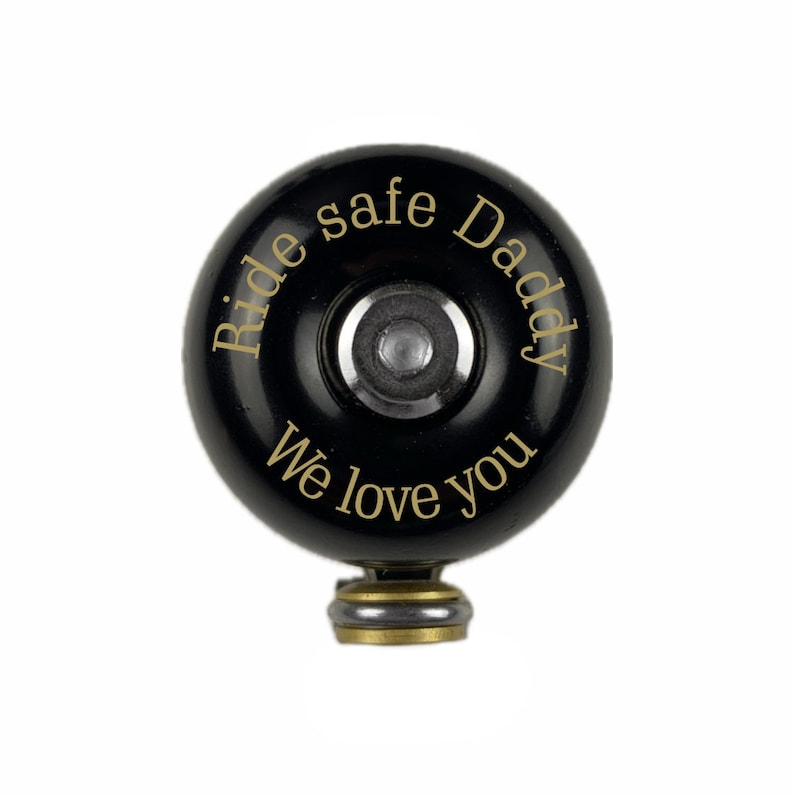 May include: Black bicycle bell with gold lettering that reads "Ride safe Daddy We love you".