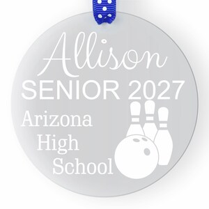 May include: A silver round ornament with the text "Allison Senior 2027 Arizona High School" and a white bowling ball and pins graphic.