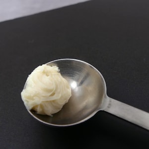 May include: A set of three ceramic mugs with a speckled, matte finish. Each mug features a different color: light blue, cream, and gray. The mugs have a simple, modern design and a comfortable handle. Perfect for coffee or tea.