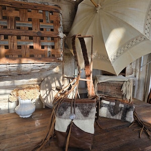 May include: A set of three ceramic mugs with a speckled, matte finish. The mugs are in shades of cream, light gray, and dark gray. Each mug has a simple, minimalist design, perfect for coffee or tea.