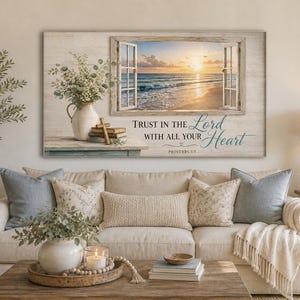 May include: A framed wall art piece featuring an open window overlooking a beach scene at sunset. The artwork includes the text "Trust in the Lord with all your heart" and a vase with flowers.