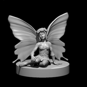 May include: A monochromatic gray figurine of a seated fairy with large, detailed butterfly-like wings. The figure wears a floral crown and a textured bodice, positioned on a smooth, cylindrical base against a solid black background.
