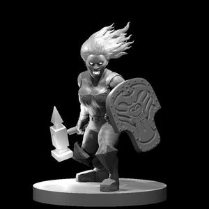 May include: A monochrome figurine of a female warrior, holding a hammer and shield. The figure has flowing hair and wears armour. The shield has a stylized design. The figurine is on a circular base.