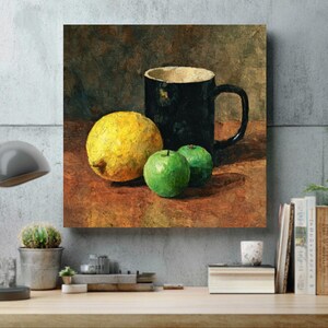 May include: A still life painting featuring a black mug, a yellow lemon, and two green apples. The mug has a light-colored interior. The fruit is arranged on a brown surface, with a dark background. The artwork is displayed on a wall.
