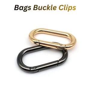 May include: Two oval-shaped bag buckle clips with spring-loaded gates. One clip has a polished gold-tone finish, and the other has a dark gunmetal finish. The text "Bags Buckle Clips" is printed in black above the two metal hardware pieces.