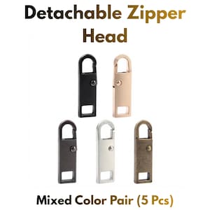 May include: Five detachable zipper heads in a rectangular shape with a top loop and a small side pin. The set includes one black, one rose gold, one dark grey, one silver, and one bronze finish. Text reads: Detachable Zipper Head Mixed Color Pair (5 Pcs).