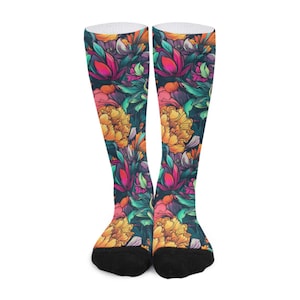 May include: A pair of crew socks featuring a vibrant floral pattern against a dark background. The design includes large yellow peonies, magenta lotus-like flowers, and teal leaves. The socks have a solid black toe and a white ribbed cuff at the top.