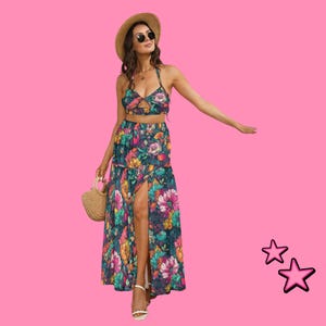 May include: A floral print two-piece outfit featuring a halter top and a high-slit maxi skirt. The ensemble includes a straw hat, sunglasses, and a woven handbag. The outfit is adorned with a vibrant floral pattern in shades of pink, blue, and yellow.