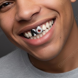 May include: A close-up shot of a person smiling, revealing silver and gem-set teeth grillz. The grillz incorporate a red gemstone and a polished silver design, adding a touch of luxury to the smile.