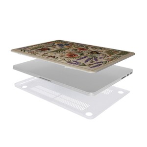 Two-piece floral MacBook case exploded view showing botanical printed top cover, laptop, and clear vented bottom shell