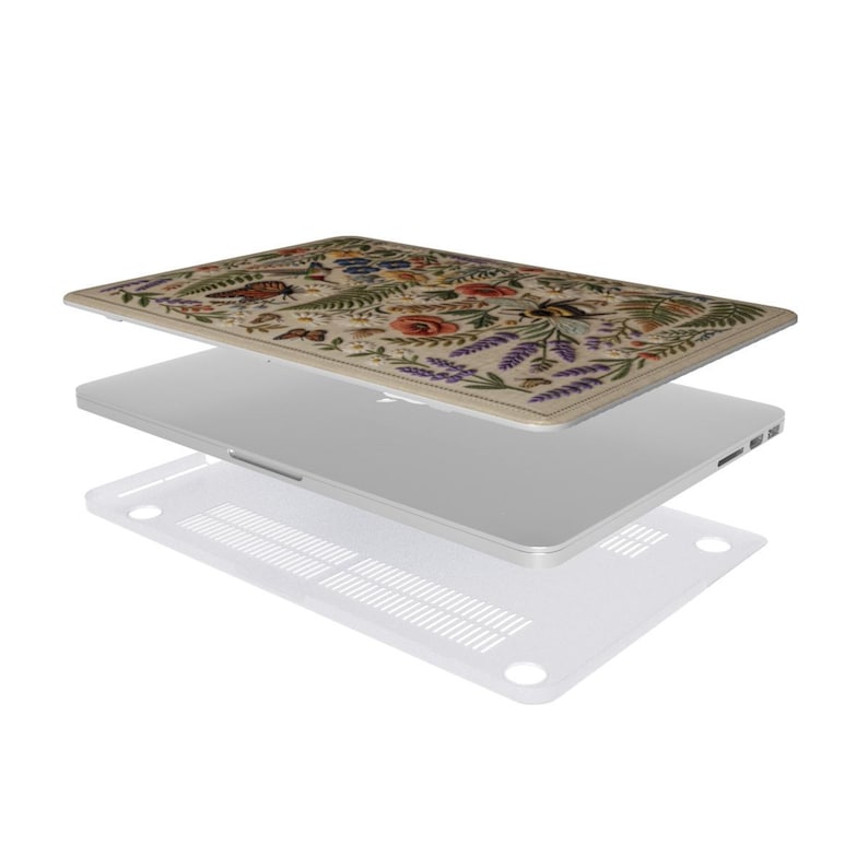 Two-piece floral MacBook case exploded view showing botanical printed top cover, laptop, and clear vented bottom shell