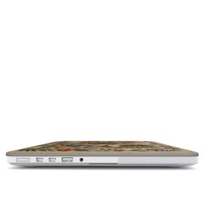 Side view of floral MacBook case showing precise cutouts for MagSafe USB-C and headphone jack, slim hard shell fit