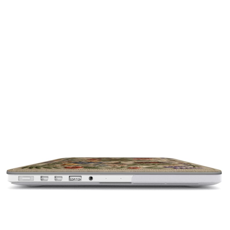 Side view of floral MacBook case showing precise cutouts for MagSafe USB-C and headphone jack, slim hard shell fit