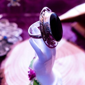Anillo grande ovalado de plata de ley con ónix negro y marco gótico calado.