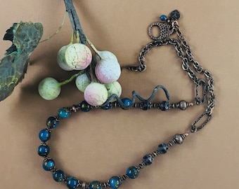 Single strand beaded necklace with teal semiprecious stones, copper beads and chain, toggle clasp