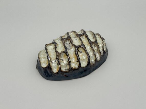Organic handmade ceramic sculpture that doubles as modern interior art — the kind of tactile, one-of-a-kind piece you'd find in a boutique gallery.