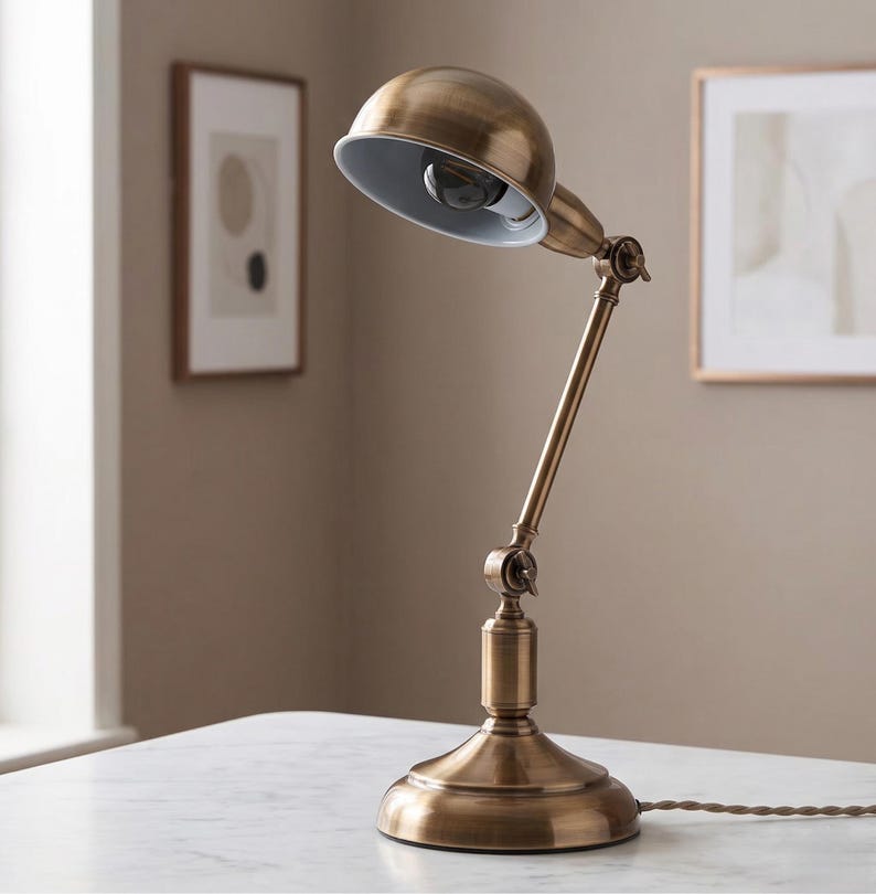 Classic brass bedside lamp on a white side table in a soft modern interior