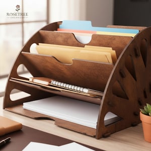 May include: A wooden desk organizer with multiple compartments for files and stationery. The organizer is made of dark brown wood and has a curved design. The top section holds file folders in various colors, while the lower sections hold paper and a notebook. The logo "ROSETREE ORGANIZER" is visible.