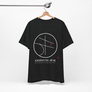 May include: Black t-shirt with a white circular graphic design and the text "GEIJYUTU JUJI" and "My imagination creates new worlds." A red plus sign is inside the circle. The shirt is hanging on a wooden hanger.