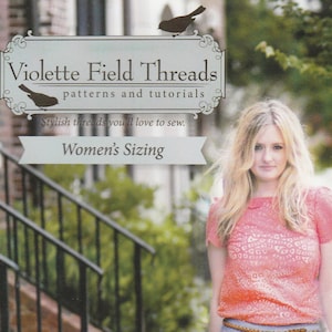 May include: A sewing pattern for pleated trousers and a skirt, called "Whitney", from Violette Field Threads. The pattern is for women's sizes 2 to 16. The pattern cover features a woman wearing a pink top and light blue trousers.