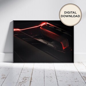 Puede incluir: Una impresión de arte mural enmarcada que muestra un primer plano del compartimento del motor de un Lamborghini negro, iluminado por tiras de luz de neón rojas. La imagen muestra el logotipo y texto de Lamborghini, con una insignia DIGITAL DOWNLOAD.