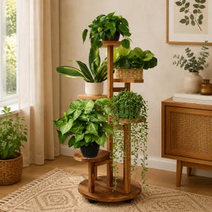 May include: A multi-tiered wooden plant stand with a central vertical support and circular shelves at varying heights. The stand holds several potted green plants, including a trailing vine, a broad-leafed plant, and a small potted shrub.