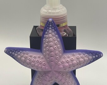 Dispensador de jabón con forma de estrella de mar rosa y morada