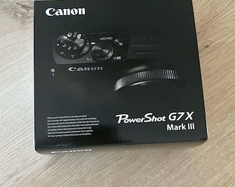 Cámara digital Canon PowerShot G7 X Mark III con objetivo luminoso y diseño compacto.
