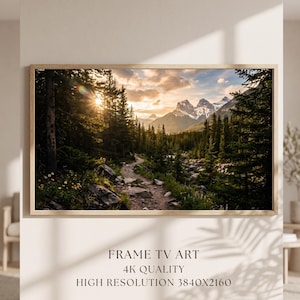 May include: A framed landscape print depicting a mountain scene with a path through a forest. The artwork shows a sunset with sunlight filtering through the trees. The text at the bottom reads "FRAME TV ART, 4K QUALITY, HIGH RESOLUTION 3840X2160."