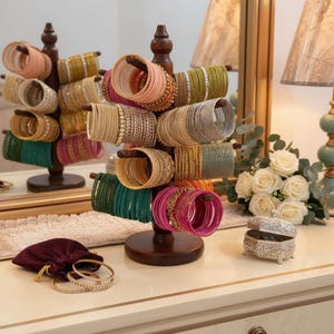 May include: A rustic wooden sign with the text "Welcome to our home" in white lettering. The sign has a distressed finish and a simple, inviting design, ideal for front door decor.