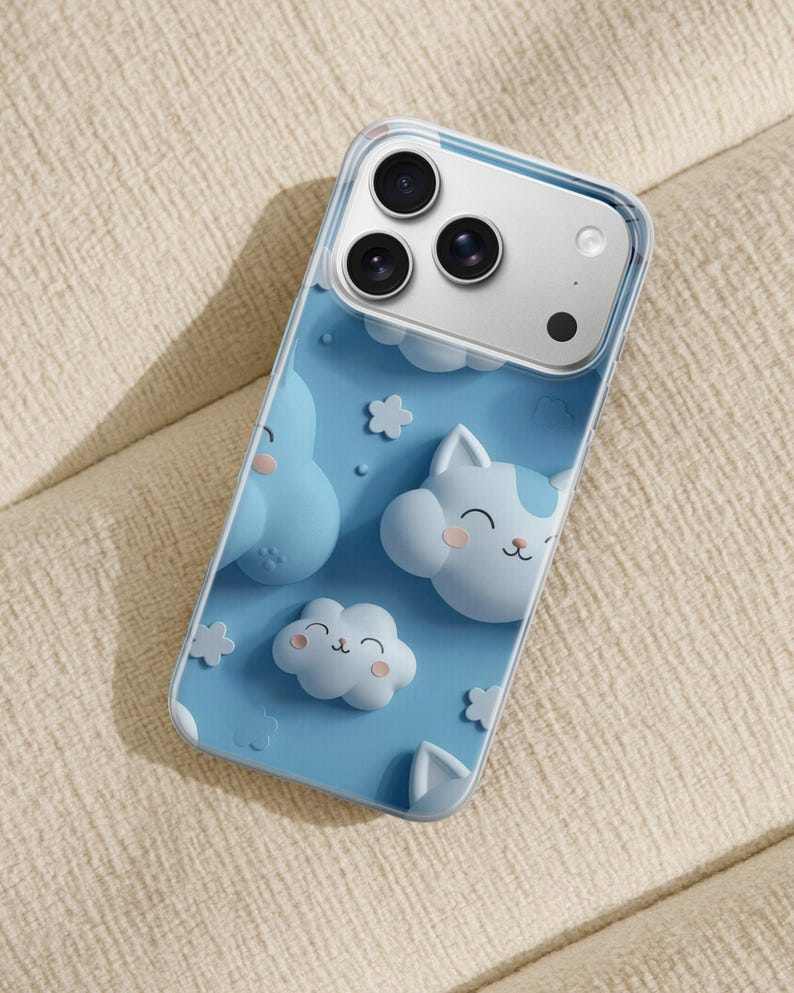 May include: A clear smartphone case featuring a light blue background with raised, three-dimensional cartoon clouds and cat-shaped cloud characters. The design includes small white flower shapes and a triple-lens camera cutout at the top.