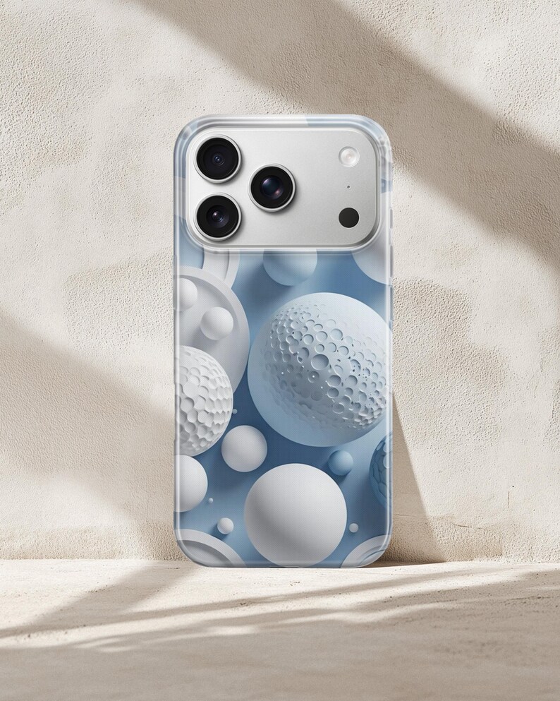 May include: A smartphone case featuring a light blue background decorated with various white spheres, including some with textured, cratered surfaces. The case has a clear border and a cutout section at the top for the phone camera lenses.