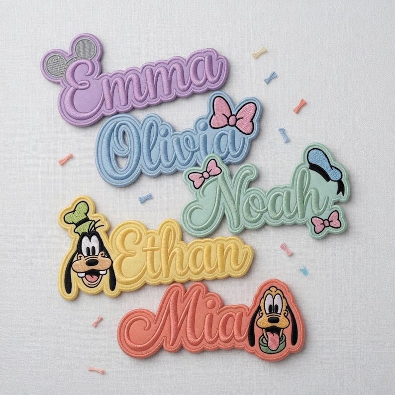 May include: Embroidered name patches in pastel colors, featuring names like Emma, Olivia, Noah, Ethan, and Mia. Each patch has a Disney character design, including Mickey Mouse ears, bows, and character faces. The patches are in various colors like lavender, blue, yellow, and coral.