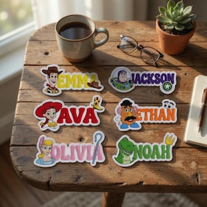 May include: Six custom name labels featuring Toy Story characters. The labels display the names EMMA in yellow, JACKSON in purple, AVA in red, ETHAN in orange, OLIVIA in pink, and NOAH in green, each accompanied by a character illustration.
