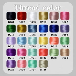 May include: A color chart of embroidery thread samples. The image displays a variety of thread colors, each in a small square with a corresponding code. The text "Thread color" is at the top. Colors include black, red, white, gold, pink, green, blue, purple, yellow, orange, and tan.