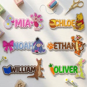 May include: Six embroidered name patches featuring Winnie the Pooh characters. The names Mia, Chloe, Noah, Ethan, William, and Oliver are displayed alongside Piglet, Pooh, Eeyore, Tigger, Roo, and Rabbit with associated icons like flowers, honey, bows, and carrots.
