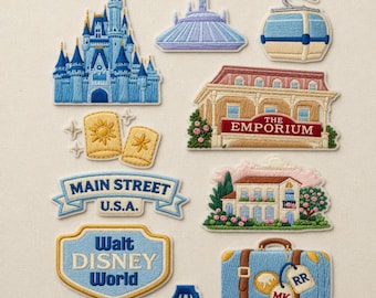 May include: Embroidered patches featuring iconic Disney park imagery. Includes Cinderella's castle, Space Mountain, a gondola, The Emporium, Main Street USA banner, a house, Walt Disney World sign, a suitcase, and a bridge.