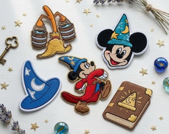 May include: A collection of embroidered patches featuring a broom carrying two buckets, a Mickey Mouse head in a blue wizard hat, a blue wizard hat, a full-body Mickey Mouse in a red robe and blue hat, and a brown spellbook with a gold hat icon.